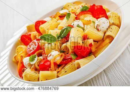 Roasted Pepper Tomato Mozzarella Pasta Salad In White Bowl On White Wood Table, Close-up