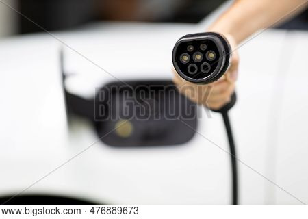 Progressive New Alternative Clean Energy Vehicle And Electric Charging Device Concept. Focus Closeup