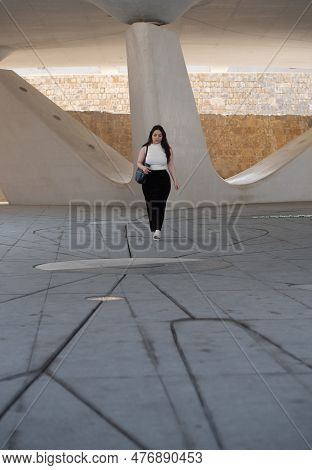 Young Attractive Woman Wearing Casual And Holding A Handbag Clothing Walking Outdoors In The City.