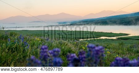 Fog Layers Rols Along Top Of Yellowstone River With Mountains Inthe Distance