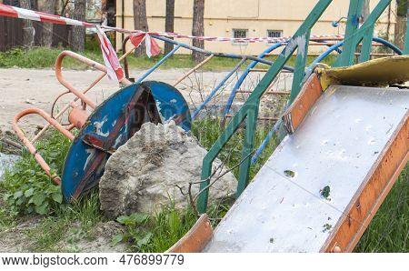 Affected After The Bombing Of Multi-storey Residential Buildings. A Playground Was Destroyed In Fron