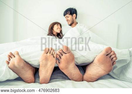 Happy Young Couple Relaxing At Home In The Morning.
