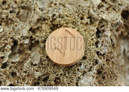 Wooden Rune Eihwaz On Stone Outdoors, Closeup