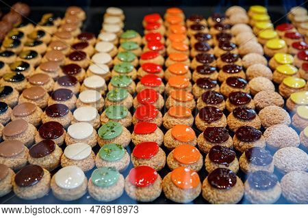 French Pastries On Display In Store Window Of Cafe Or Bakery.