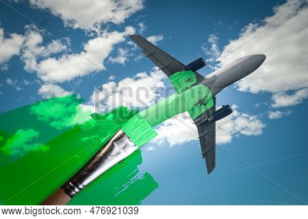 Brush Painting Green An Aircraft. Greenwashing Malpractice, Zero Emissions, Saf Or Sustainable Aviat