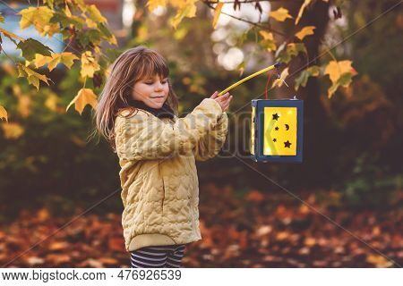 Little Preschool Kid Girl Holding Selfmade Traditional Lanterns With Candle For St. Martin Processio