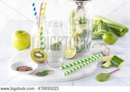 A Blender Container Filled With Ingredients To Make A Healthy Green Smoothie.