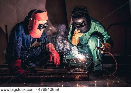 Metal Welding Steel Works Using Electric Arc Welding Machine To Weld Steel At Factory. Metalwork Man