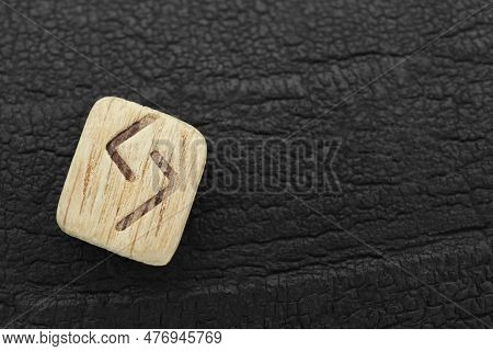 Wooden Rune Jera On Black Textured Background, Top View. Space For Text
