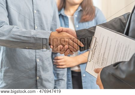Close Up Hand Of Young Couple New Landlord, Tenant Or Rental Handshake With Home, Apartment Agent Or