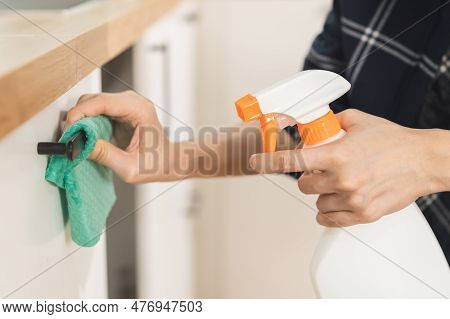 Hand Of Asian Young Woman Cleaning Wooden Cupboard, Cabinet, Using Rag Rub Dust,hand Holding Spray B