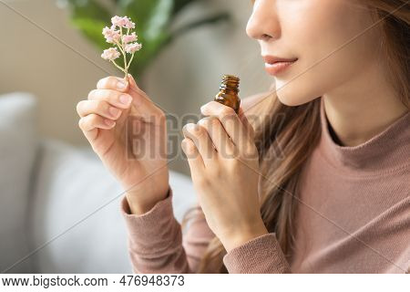 Aromatherapy, Asian Young Woman, Girl Hand Holding Flower, Bottle Of Essential Perfume Oil, Enjoying