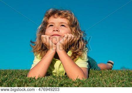 Happy Child On Green Grass. Summer Dream. Kid Dreams On Grass. Childhood Dream. Daydreamer Child. Dr