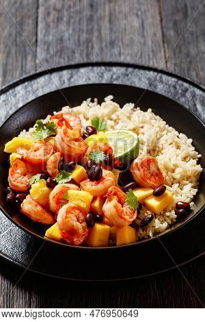 Caribbean Grilled Shrimps With Black Beans, Mango Pineapple Salsa Served With Brown Rice In Black Bo