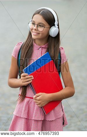 Teen Girl Has Estudy With Books. Teen Girl Has Estudy In Headphones. Teen Girl Has Estudy