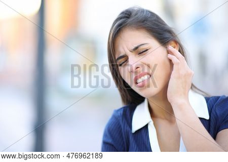 Stressed Woman Complaining Suffering Earache In The Street