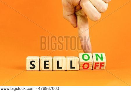 Sell On Or Off Symbol. Businessman Turns Wooden Cubes And Changes Word Sell Off To Sell On. Beautifu