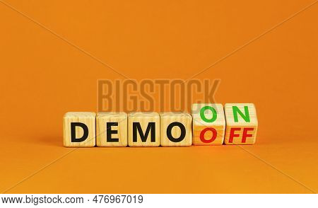 Demo On Or Off Symbol. Businessman Turns Wooden Cubes And Changes Word Demo Off To Demo On. Beautifu