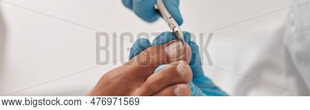 Professional Podiatrist Uses Shny Clipper To Cut Toenail Of Man In Beauty Salon