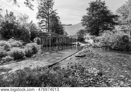 The Badgworthy Water River Flowing Under Malmsmead Bridge In Exmoor National Park