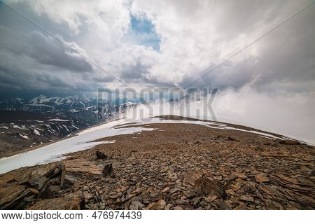 Awesome Top View Through Clouds To High Snowy Mountains. Scenic Landscape With Beautiful Snow Mounta