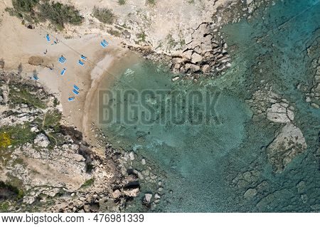 Drone Aerial Of Beach Umbrellas And People Swimming In The Sea. Summer Holidays In The Sea.