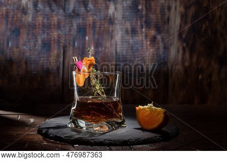 Glass Of Whiskey Garnished With And Orange. A Glass Of Alcohol On The Table. Composition With A Glas
