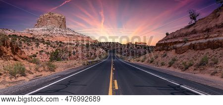 Scenic Road In The Dry Desert With Red Rocky Mountains In Background. Twillight Sky Art Render. Near