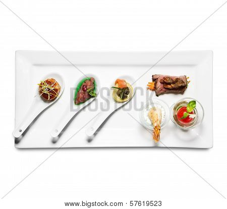 assorted cold appetizers in plate on white background