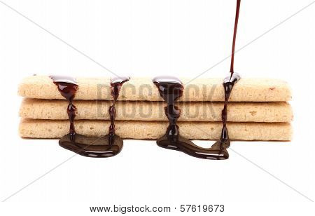 Stream chocolate on stics of biscuit.