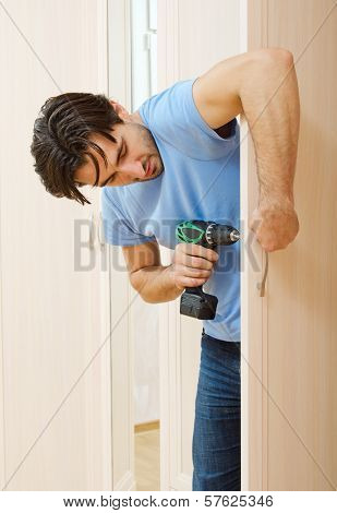Man Repairing The Door Handle Furniture