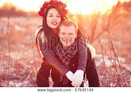 Happy young couple smiling and hugging