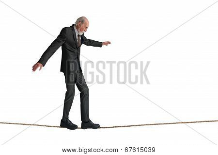 Senior Man Walking A Tightrope