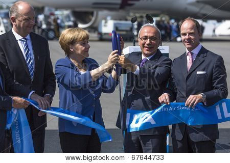 BERLIN, GERMANY - MAY 20, 2014: German Chancellor Angela Merkel, Turkish Minister of transport Lutfi Elvan and CEO Mr Christian (C.-R.) open up the International aviation and space exhibition ILA.