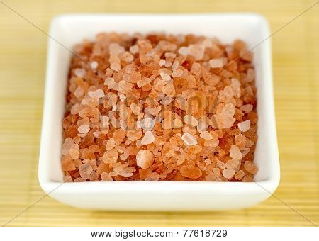 Bowl Of Pink Himalyan Rock Salt Against Wooden Background