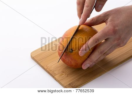 Kitchen Knife Sinking Into Mango For A First Cut