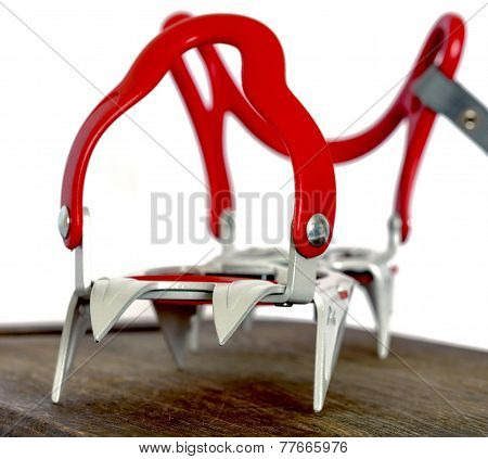 Grey alpine climbing crampons close up image