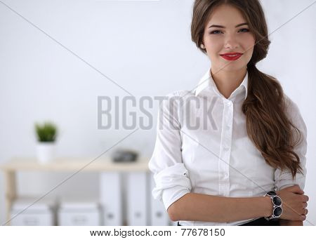 Attractive businesswoman with her arms crossed stnding