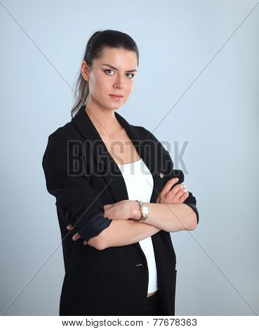 A young woman standing, isolated on graybackground