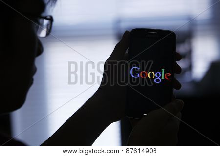 Kuala Lumpur,Malaysia 9th April 2015,Kuala Lumpur,Malaysia 9th April 2015, Young man Using Google Web Search on her Smart Phone.