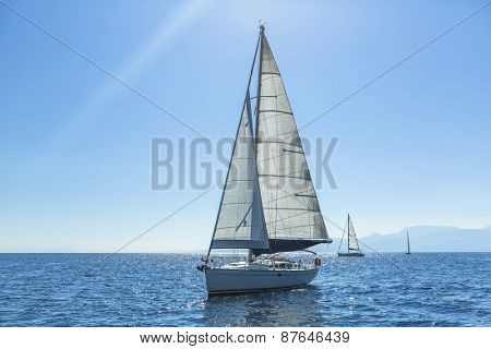 Ship yachts with white sails in the open Sea. Sailing. Luxury boats.