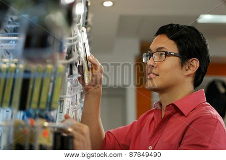 Happy Chinese Man Ordering Usb Drive In Computer Shop