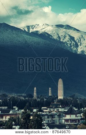 Ancient pagoda in Dali old town with snow capped Mt Cangshan, Yunnan, China.