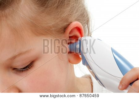 Taking temperature with ear thermometer