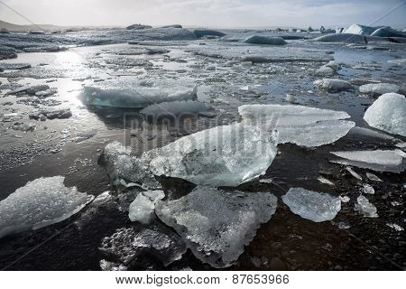 Glacier ice lagoon in Jokullsarlon, Iceland. The glacier breaks up into ice blocks in the lagoon before flowing out to sea as icebergs.
