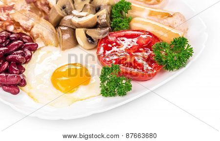Fried egg with sausage on plate.