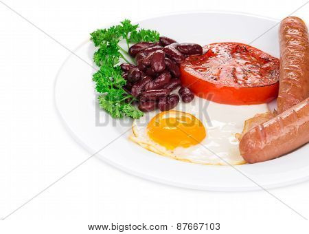 Fried egg with sausage on plate.