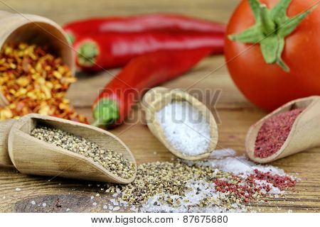 Tomato, Chili Pepper, Salt And Pepper On Rustic Wood Table