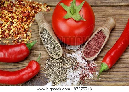Tomato, Chili Pepper, Salt And Pepper On Rustic Wood Table