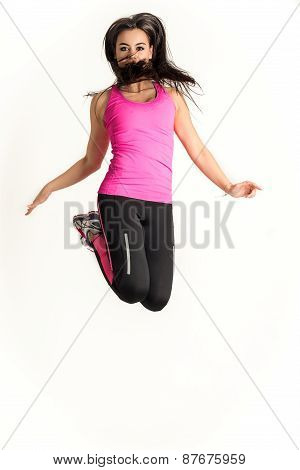 Young fitness woman jumping high